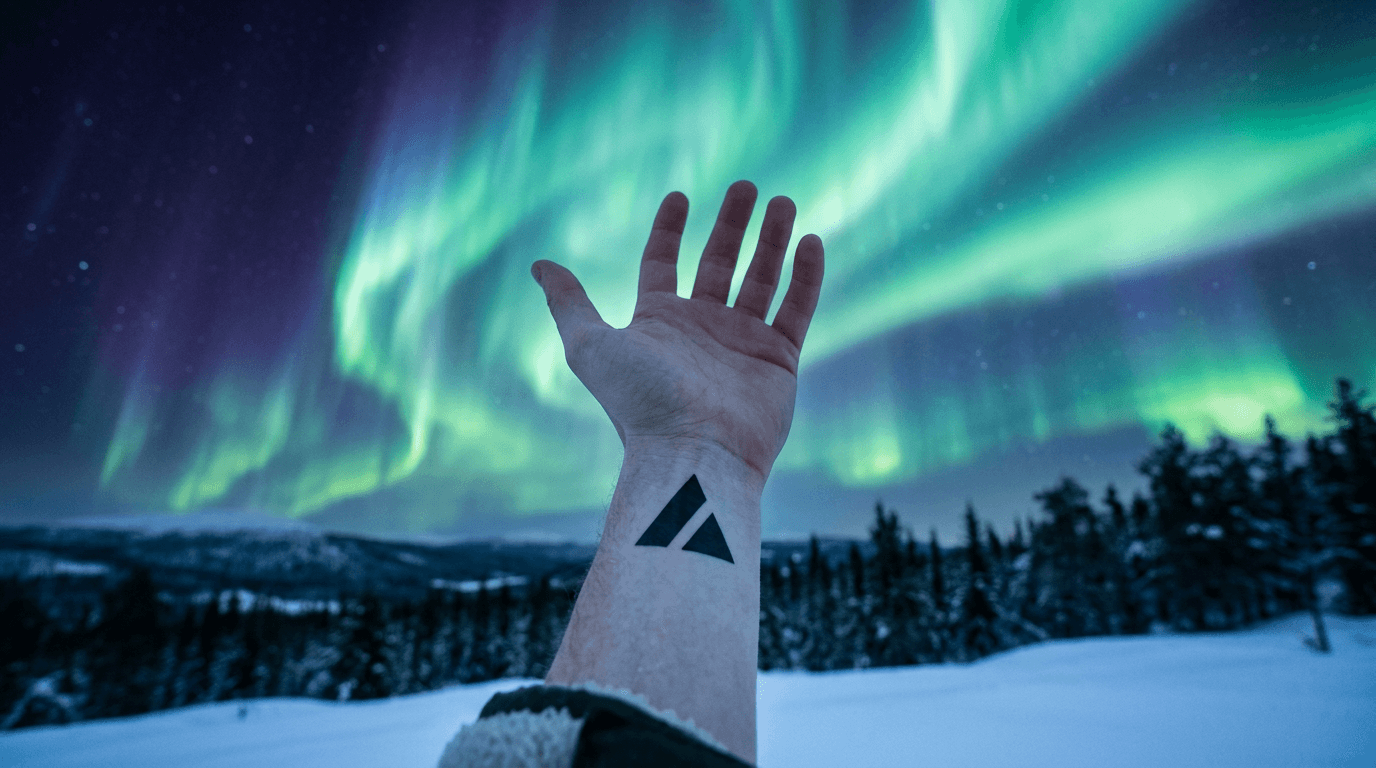 A hand wearing a black theProject mark under bands of northern-light color