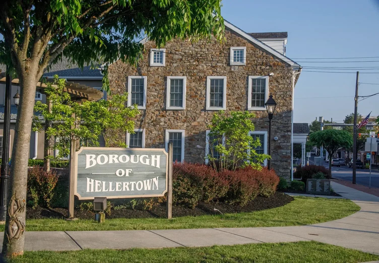 Borough of Hellertown sign beside a stone civic building
